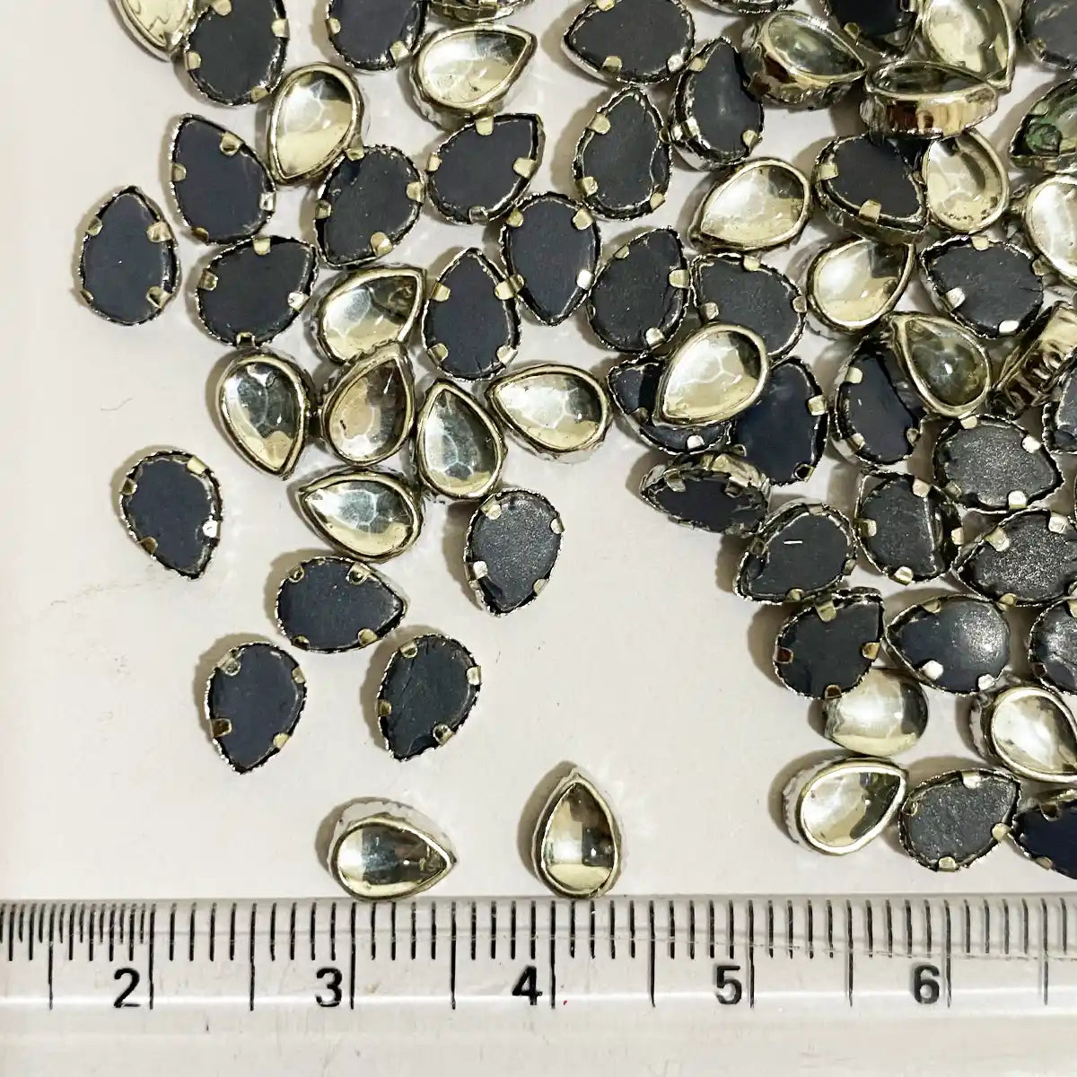 Kundan Stone Framed Drop Shape 6mmx4mm White Color Silver Base (20grams)